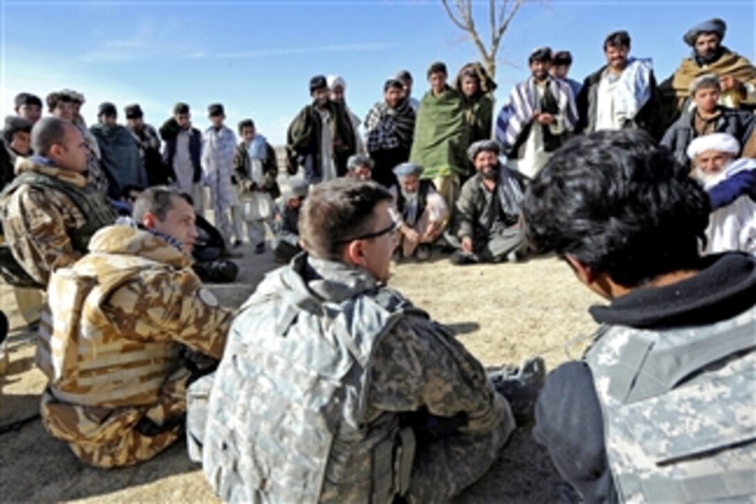 U.S. Air Force Capt. Ryan Weld (center) and Romanian Forces from Task Force Black Scorpion talk with villagers during a shura in Khleqdad Khan, Afghanistan, on Dec. 19, 2010.  Weld is assigned to the Provincial Reconstruction Team Zabul.  