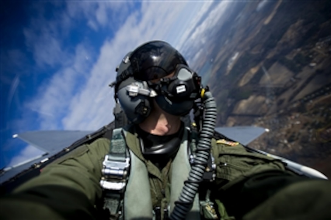 U.S. Air Force Staff Sgt. Michael Keller documents an F-15E Strike Eagle aircraft from the 335th Fighter Squadron during a training mission over North Carolina, Dec. 17, 2010. Keller, an aerial combat photographer is assigned to the 1st Combat Camera Squadron.