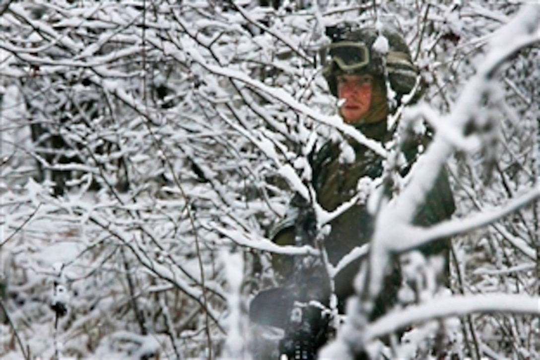 A U.S. Marine patrols the military operations in urban terrain training site aboard at Fort Pickett, Va., Dec. 13, 2010. For two weeks, elements of the 22nd Marine Expeditionary Unit conducted a series of training events designed to prepare them for upcoming subsequent deployment in 2011. The Marines and sailors of the unit recently began an aggressive series of more complex pre-deployment exercises designed to train and test the unit's ability.