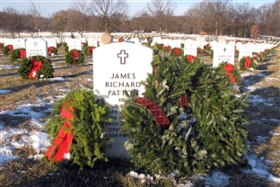 Christmas wreaths adorn the grave of Army Staff Sgt. James R. Patton at Arlington National Cemetery, Dec. 21, 2010. AFPS writer Donna Miles recently met Patton's mother, and paid a visit to his grave to lay a wreath at his grave; she shares her experience in a commentary. Patton was serving his seventh overseas deployment since 9/11 with the 3rd Battalion, 75th Ranger Regiment, when he died in a helicopter crash in Tikrit, Iraq, on April 18, 2010. 