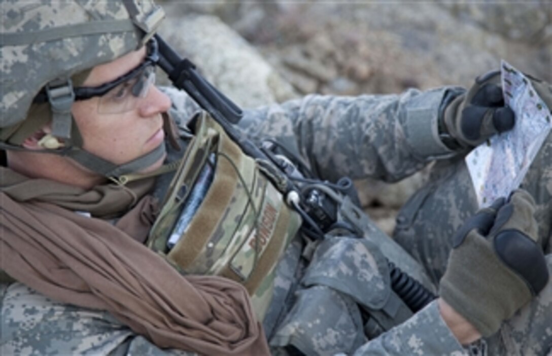 U.S. Army 2nd Lt. Aaron M. Dunson with 2nd Battalion, 327th Infantry Regiment, reads a map at a rally point in Konar province, Afghanistan, during Operation Eagle Claw II on Dec. 10, 2010.  