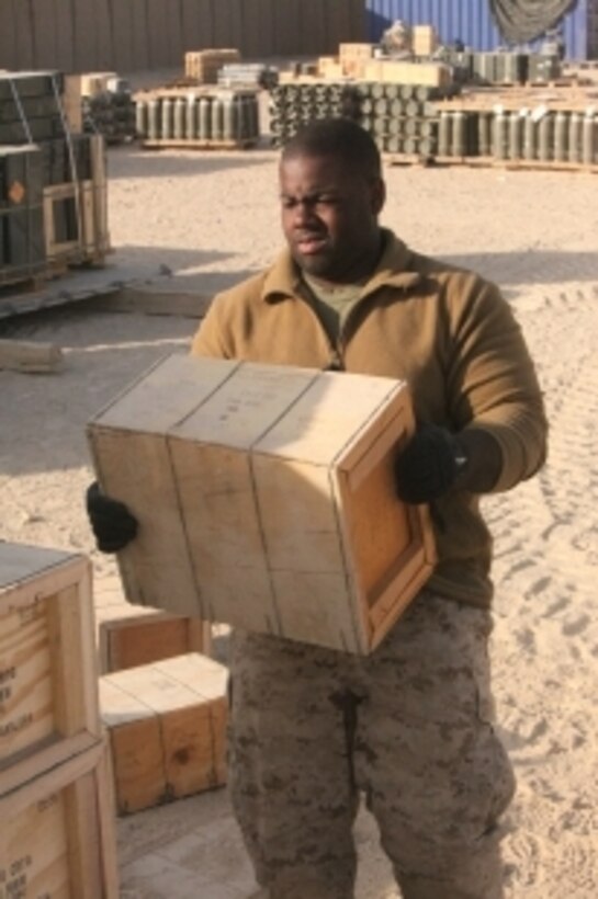 Lance Cpl. Tod D. Duncan, ammunition technician, Supply Company, Combat Logistics Regiment 15 (Forward), 1st Marine Logistics Group (Forward), carries a crate of ammunition at the Field Ammunition Supply Point at Camp Bastion, Afghanistan, Dec. 21. The Marines who work at the FASP provide all types of ammunition and explosives to coalition forces in southwestern Afghanistan.