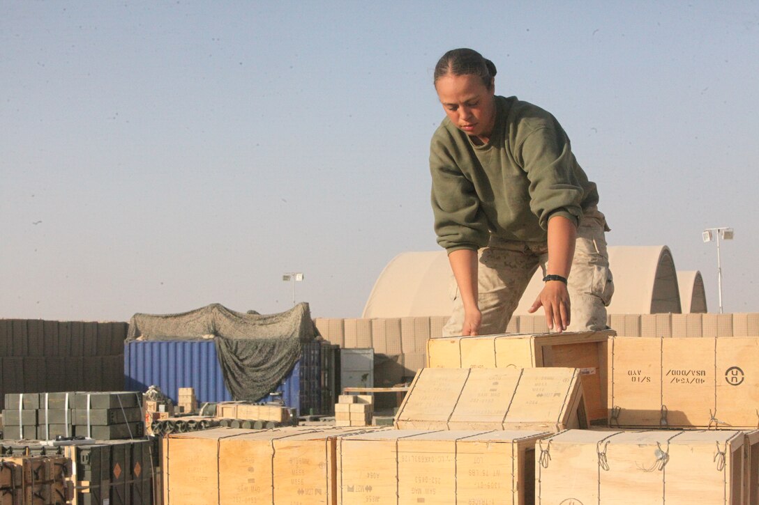 Lance Cpl. Jasmine E. Vazquez, ammunition technician, Supply Company, Combat Logistics Regiment 15 (Forward), 1st Marine Logistics Group (Forward), picks up a crate of ammunition at the Field Ammunition Supply Point at Camp Bastion, Afghanistan, Dec. 21. The Marines who work at the FASP provide all types of ammunition and explosives to coalition forces in southwestern Afghanistan.