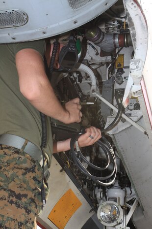 Lance Cpl. Zachary Hudson, Marine All-Weather Fighter Attack Squadron 225 avionics technician, loads cryptographic codes into a VMFA(AW)-225 F/A-18 Hornet during hot pit, hot seat training here Dec. 22.
