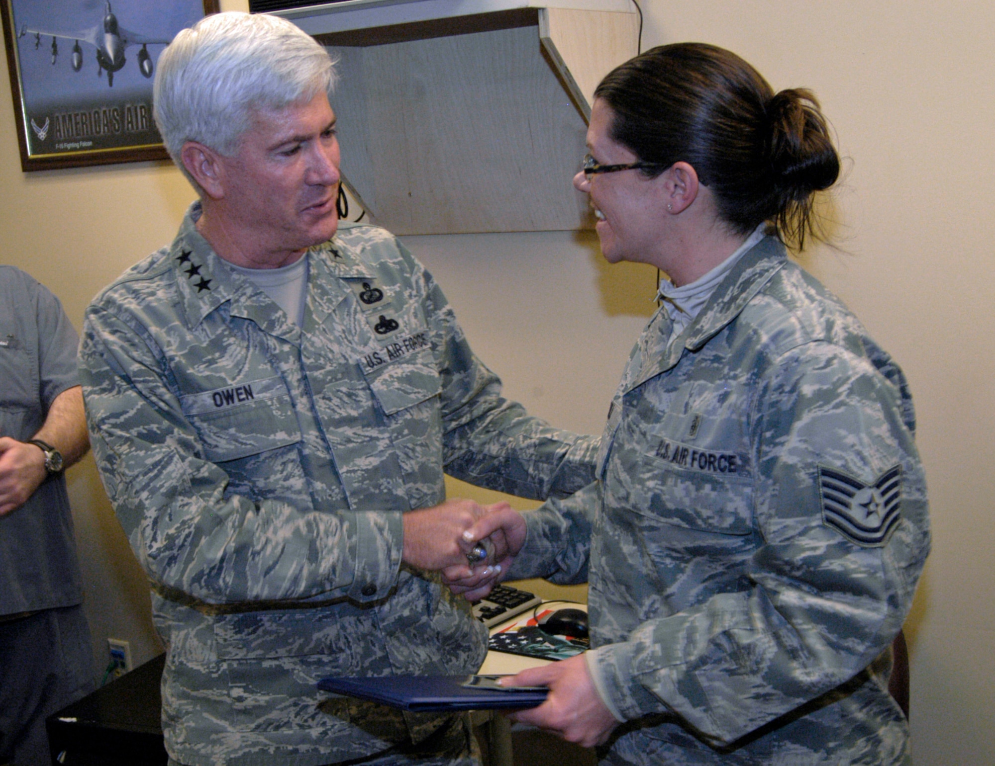 Lt. Gen. Thomas Owen congratulates Tech. Sgt. Beverly Bull following her surprise promotion to Master Sergeant Dec. 21, 2010 at Wright-Patterson Air Force Base, Ohio.  General Owen promoted Sergeant Bull via the Stripes for Exceptional Performers program. Sergeant Bull is Pediatric Flight chief with the 88th Medical Operations Squadron at Wright-Patterson Medical Center.  General Owen is commander of Aeronautical Systems Center. (U.S. Air Force photo/Derek Kaufman)