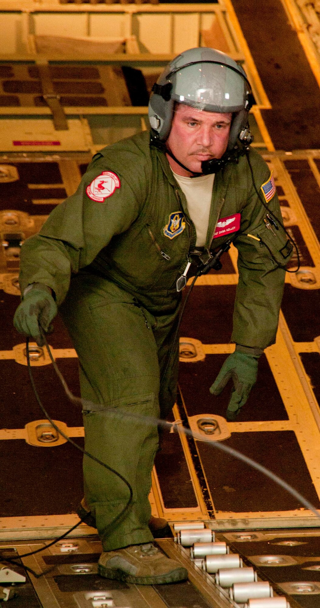 Tech. Sgt. Dana Kelley, 815 Airlift Squadron loadmaster, whips his in-flight communication cord out of the way as he prepares to secure the cargo bay of a C-130J-30 after an airdrop exercise. Reservists with the 815th AS and active-duty members from the 345th AS train side-by-side as they prepare for an upcoming deployment early next year in support of overseas contingencies in Southwest Asia. (U.S. Air Force photo by Tech. Sgt. Ryan Labadens)