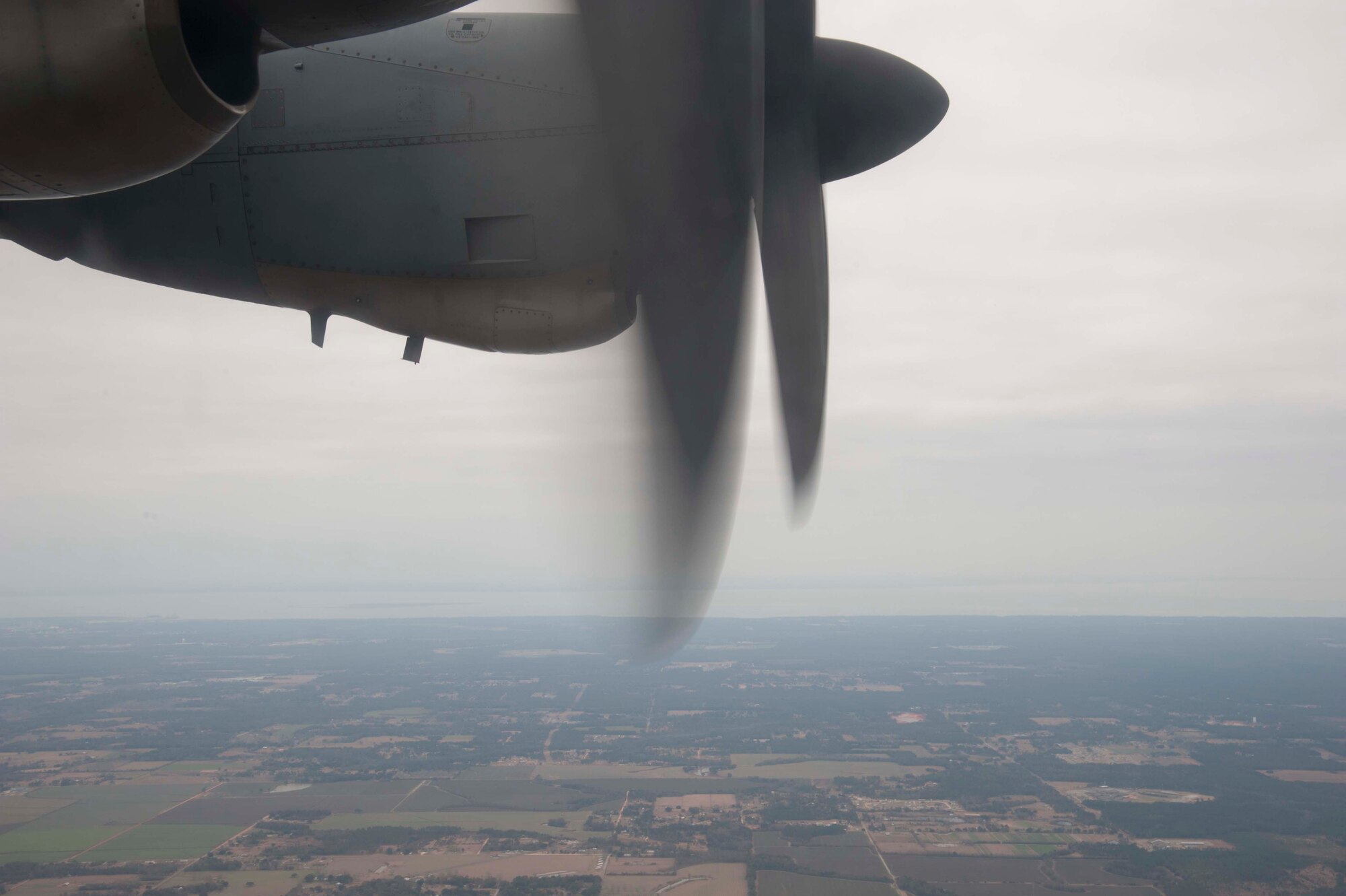 Propeller blades whir on C-130J-30 stretch model flown by members of the 815th and 345th Airlift Squdrons. The crew airdropped simulated cargo as part of their training for an upcoming deployment to Southwest Asia early next year. The 815th "Flying Jennies" and 345th "Golden Eagles," an active associate unit, work and train side-by-side as part of the 403rd Wing at Keesler Air Force Base, Miss. (U.S. Air Force photo by Tech. Sgt. Ryan Labadens)