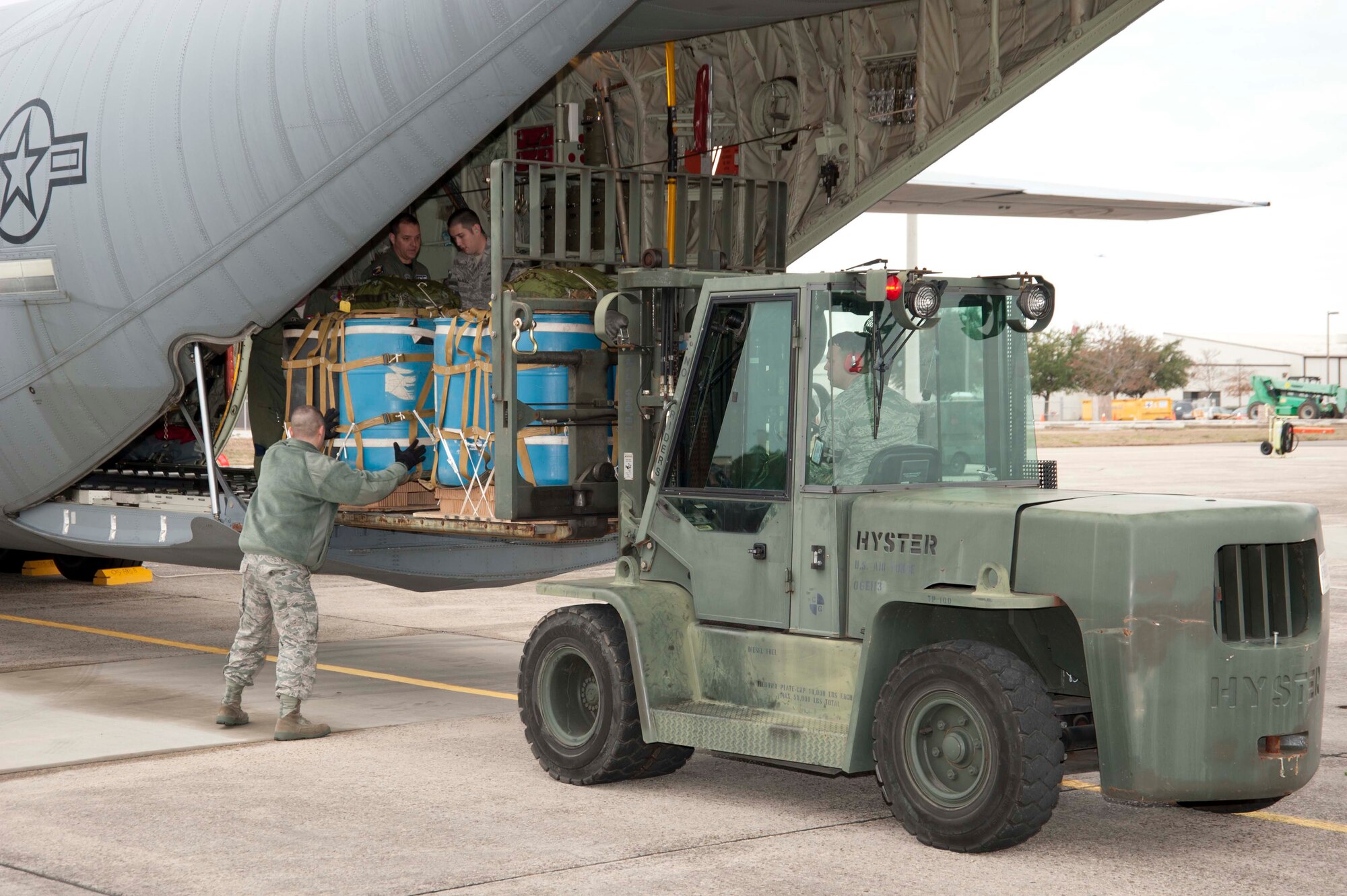 Members of the 41st Aerial Port Squadron load water barrels onto a C-130J-30 stretch model aircraft, flown by members of the 815th and 345th Airlift Squadrons. These barrels simulated cargo that was airdropped as part of the squadrons' training for their upcoming deployment to Southwest Asia. The 815th "Flying Jennies" and 345th "Golden Eagles," an active associate unit, work and train side-by-side as part of the 403rd Wing at Keesler Air Force Base, Miss. (U.S. Air Force photo by Tech. Sgt. Ryan Labadens)