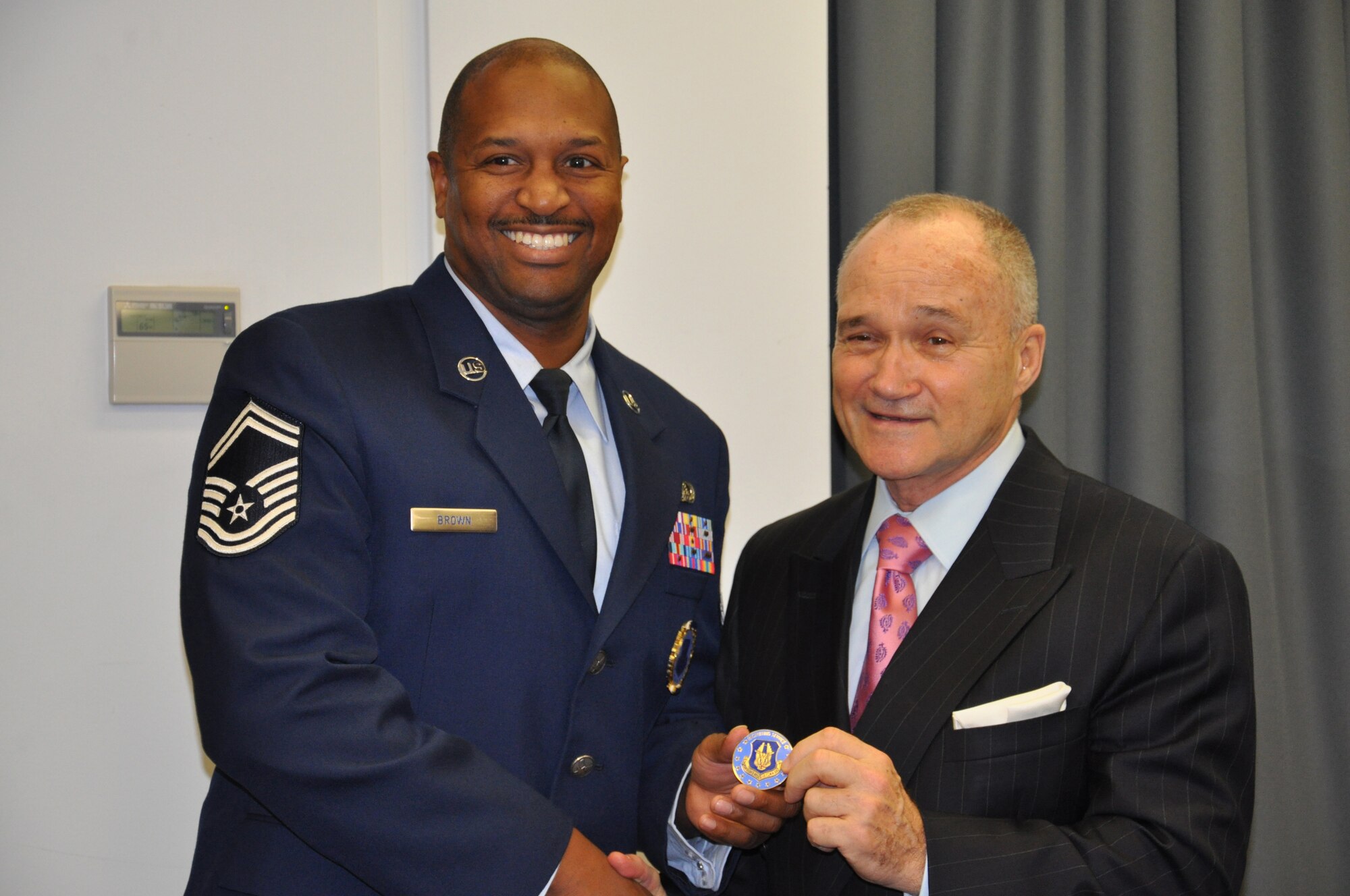 JOINT BASE MCGUIRE-DIX-LAKEHURST, N.J. -- Senior Master Sgt. Alexander Brown, senior recruiter of the 514th Air Mobility Wing, here, presents New York City Police Commissioner Raymond W. Kelly with an Air Force Recruiting badge, naming him an honorary recruiter Dec. 13 during a Reserve employer outreach trip to the New York Police Department Headquarters, New York, NY. (U.S. Air Force photo/Master Sgt. Donna T. Jeffries)
