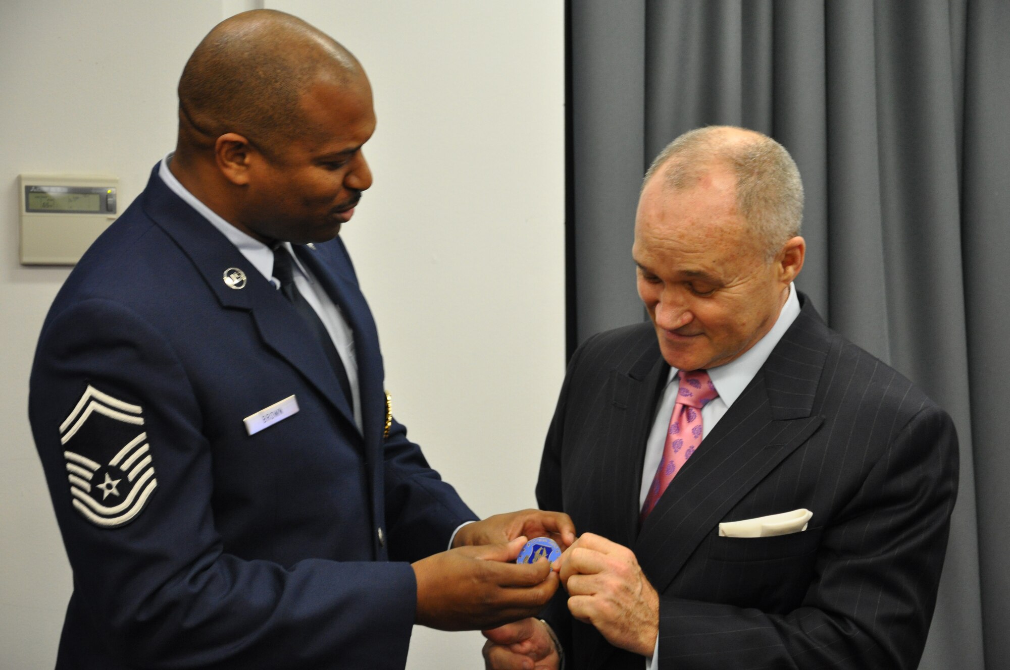 JOINT BASE MCGUIRE-DIX-LAKEHURST, N.J. -- Senior Master Sgt. Alexander Brown, senior recruiter of the 514th Air Mobility Wing, here, presents New York City Police Commissioner Raymond W. Kelly with an Air Force Recruiting badge, naming him an honorary recruiter Dec. 13 during a Reserve employer outreach trip to the New York Police Department Headquarters, New York, NY. (U.S. Air Force photo/Master Sgt. Donna T. Jeffries)