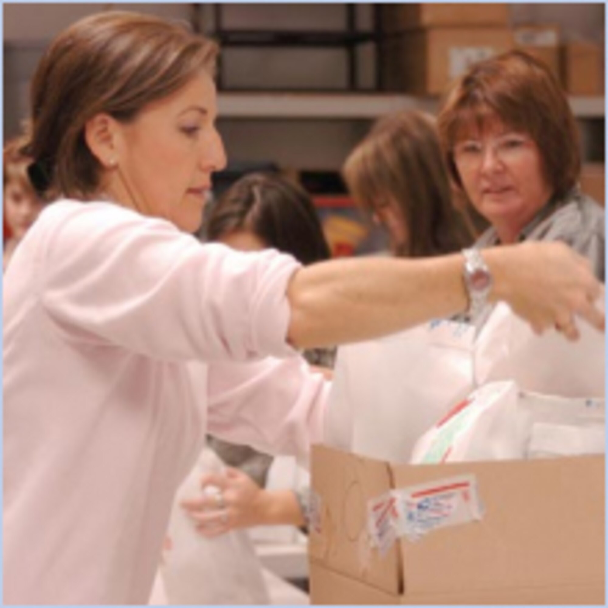 Jean Morris, wife of Col. Shaun Morris, OO-ALC vice commander, puts the cookie bags into large boxes. (U.S Air Force photo by A1C Melissa Dearstone)