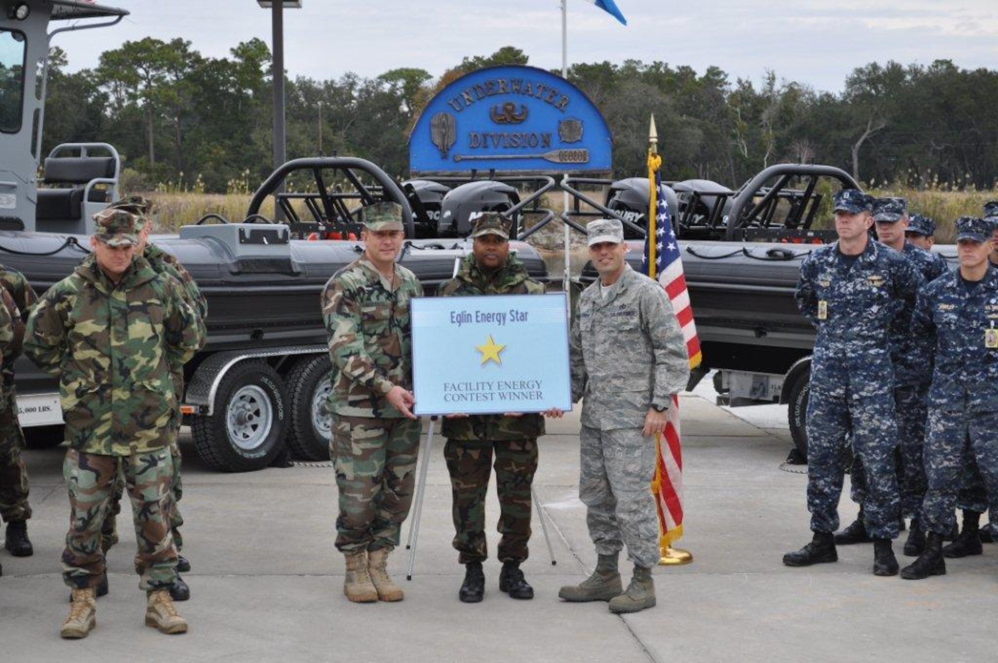 Col. Sal Nodjomian, 96th Air Base Wing commander presents Capt. Adam Guziewicz, Naval School Explosive Ordnance Disposal commander, and Mineman First Class Troy Reed, with the Quarterly Energy Contest Award. The EOD School posted record savings over the quarter with 37 percent energy savings, primarily by turning off computers when not in use. Other competitors were the 9th Special Operations Squadron and 46th Test Wing Base Operations. The total combined reduction for all three buildings averaged more than13 percent, saving more than $2,000 during a 30-day period. Energy awareness and cultural change are the keys to Team Eglin's success. This year, 13 buildings have participated in four energy contests and have saved more than $16,000. (U.S. Air Force photo/James Reese)

