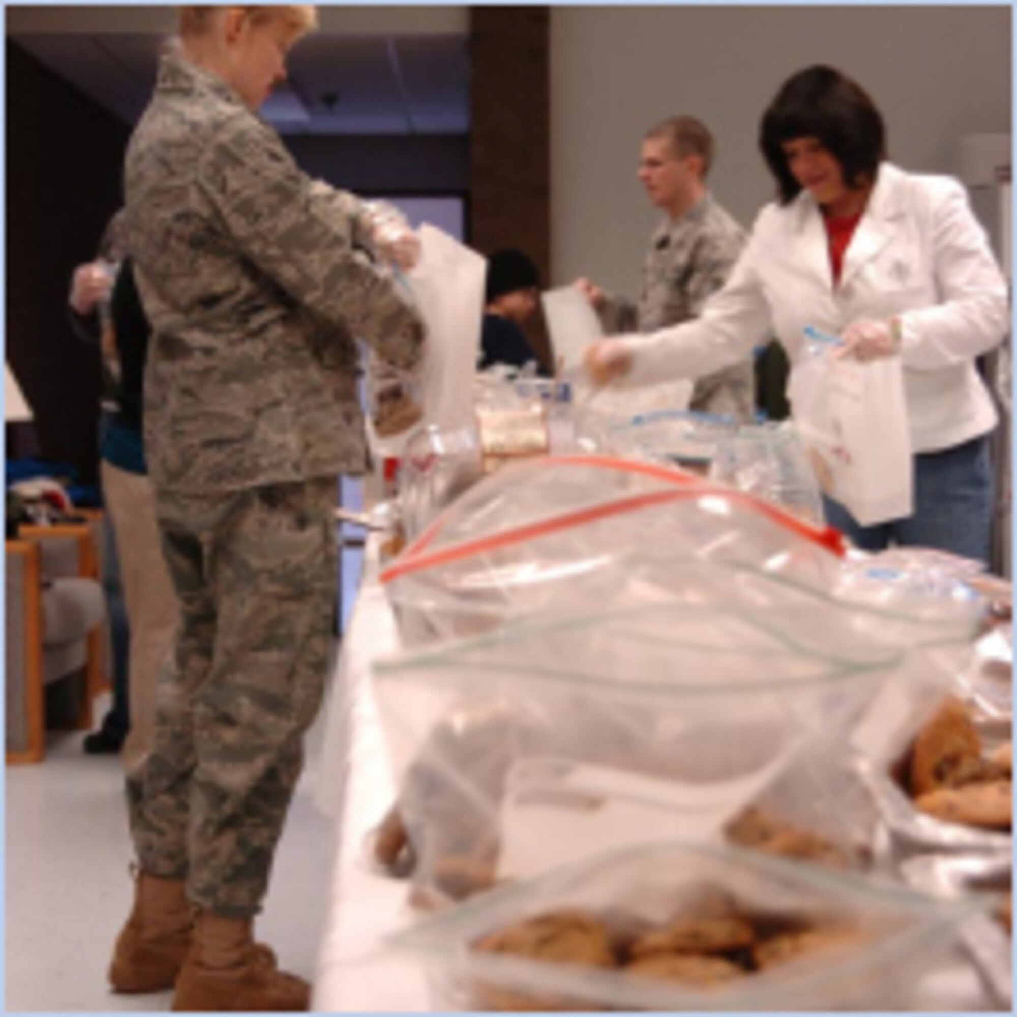 Capt. Karin Werner, 448th Supply Chain Management Group, works on the cookie line. (U.S. Air Force photo by A1C Melissa Dearstone)