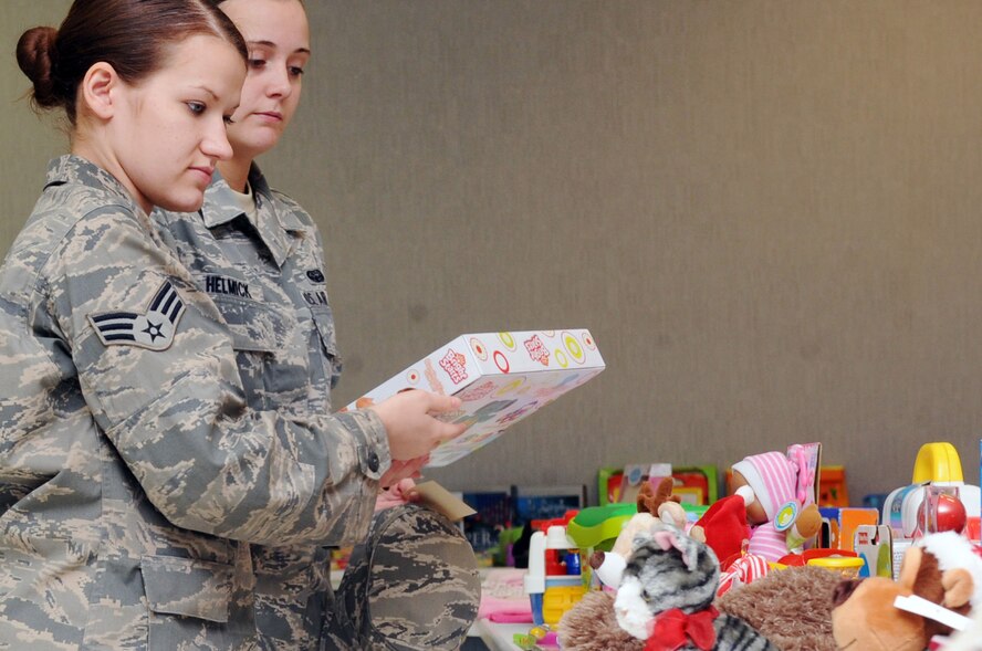 Senior Airman Tasha Holmes, 2nd Communications Squadron, looks at Christmas gifts during the toy giveaway at the Chapel 2 Annex on Barksdale Air Force Base, La., Dec. 22. The toy giveaway was for Airmen E-4 and below who needed a little help with Christmas. (U.S. Air Force photo/Senior Airman Brittany Y. Bateman)(RELEASED) 
