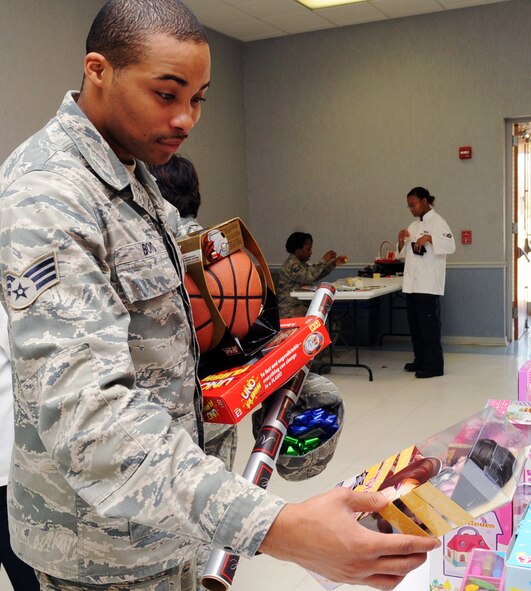 Senior Airman Michael Boyd, 2nd Force Support Squadron fitness specialist, shops for his sister?s and brother?s Christmas gifts during the toy giveaway at the Chapel 2 Annex on Barksdale Air Force Base, La., Dec. 22. The toy giveaway was for Airmen E-4 and below who needed a little help with Christmas. (U.S. Air Force photo/Senior Airman Brittany Y. Bateman)(RELEASED) 