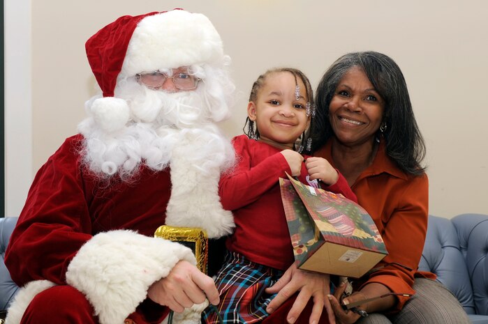 Rose Alexander and her granddaughter Krista Cheatham meet with Santa during the children of deployed members holiday party held at the chapel annex Dec. 18, 2010. The holiday party was held by the Honorary Commanders Advisory Council with gifts and food supplied by local businesses. Mrs. Alexander is assigned to the 628th Air Base Wing public affairs office. (U.S. Air Force photo/Staff Sgt. Marie Brown)