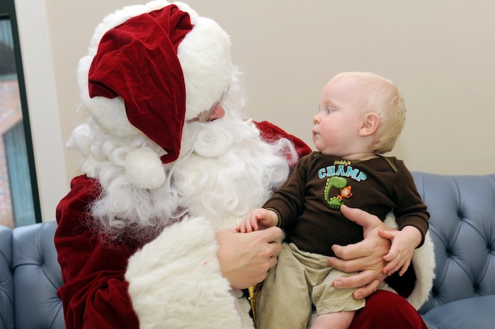 Aiden Adams sits on Santa's lap during the children of deployed members holiday party held at the chapel annex Dec. 18, 2010, on Joint Base Charleston, S.C. The holiday party was held by the Honorary Commanders Advisory Council with gifts and food supplied by local businesses. Aiden is the son of Senior Airman Stefan Adams, assigned to the 437th Operations Support Squadron. (U.S. Air Force photo/Staff Sgt. Marie Brown)