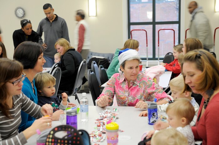 Col. Martha Meeker talks with children and spouses of deployed members while they await the arrival of Santa during the children of deployed members holiday party held at the chapel annex Dec. 18, 2010, on Joint Base Charleston, S.C. The holiday party was held by the Honorary Commanders Advisory Council with gifts and food supplied by local businesses. Colonel Meeker is the JB CHS commander. (U.S. Air Force photo/Staff Sgt. Marie Brown)