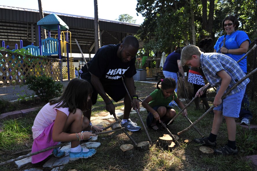 Kenny Hasbrouck, a Miami HEAT player, works on a team building activity with children at the outdoor classroom at the Youth Center, Hurlburt Field Fla., Sept. 30, 2010. The classroom became the 29th Arbor Day Foundation and Dimensions Educational Research Foundation-certified Nature Explore classroom in the country in November 2009. (DoD photo by U.S. Air Force Staff Sgt. Stephanie Jacobs/RELEASED)
