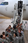 Wing leaders bid farewell to Airmen as they board a plane at Lackland Air Force Base, Texas, Dec. 22.  More than 45 Airmen, the majority from the 59th Medical Wing, deployed to Iraq for approximately six months in support of Operation New Dawn. (U.S. Air Force photo/Senior Airman Corey Hook)