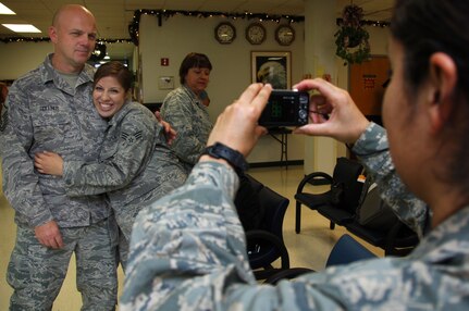 Master Sgt. Robert Gollner, 59th Surgical Inpatient Squadron (left), and Senior Airman Danelia Chairez, 59th Medical Inpatient Squadron, pose for a photo Dec. 22 at the Lackland Air Force passenger terminal. Airman Chairez was one of more than 45 Airmen, the majority from the 59th Medical Wing, who deployed for approximately six months in support of Operation New Dawn.  (U.S. Air Force photo/Senior Airman Corey Hook)