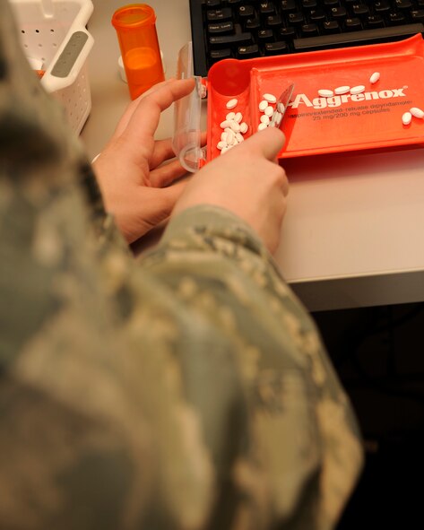 Airman 1st Class Ashley Parker, 2nd Medical Group pharmacy technician, fills prescriptions and verifies pill counts for Barksdale patients Dec. 22 at the Barksdale pharmacy. The Barksdale pharmacy provides medication for military members, retirees and dependents.  (U.S. Air Force photo/Senior Airman Allison M. Boehm)(RELEASED)