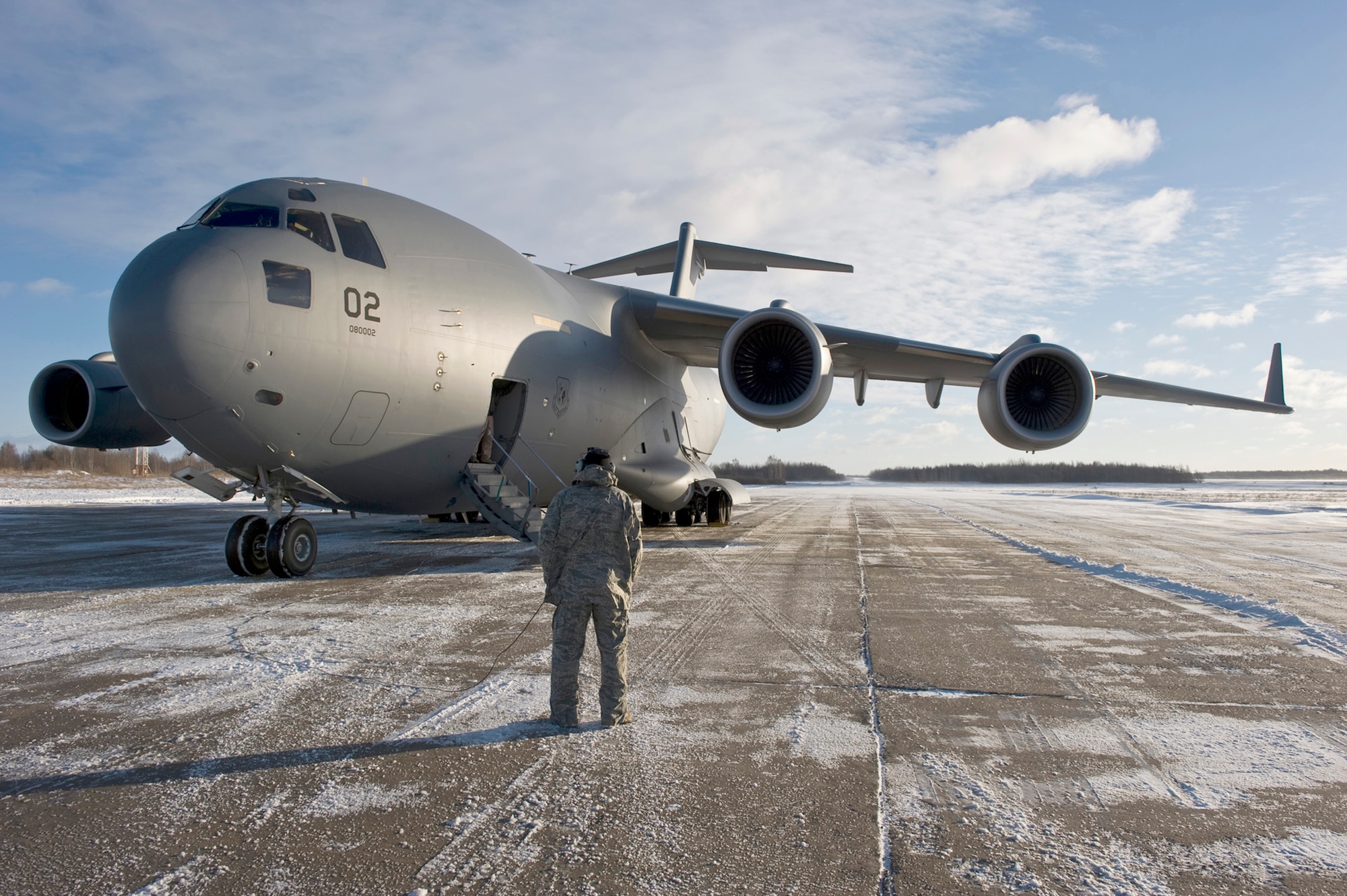 U.S. Air Force Tech. Sergeant Joseph Johns, flying crew chief from Papa, Hungary communicates with the C-17 Globemaster III pilots while on an airfield in Lithuania, Dec. 10, 2010.  The three-day mission will span over 7000 miles covering countries of Hungary, Poland, Afghanistan and Lithuania with over 75,000 tons of cargo.  (U.S. Air Force photo/TSgt Wayne Clark) (Released)