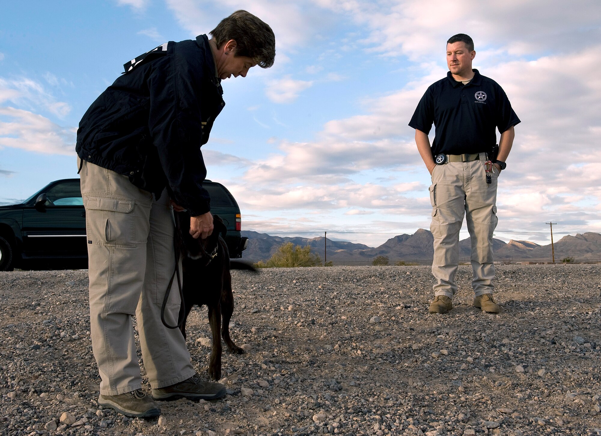 Jon Minnich discusses different explosive odor combinations with Lauren Marakas Dec. 16, 2010, at Nellis Air Force Base, Nev., during a joint explosive detection training exercise. Mr. Minnich is a U.S. Marshals Service explosive detection canine handler, and Mrs. Marakas is a senior special agent canine handler from the Bureau of Alcohol, Tobacco, Firearms, and Explosives. (U.S. Air Force photo/Senior Airman Brett Clashman)