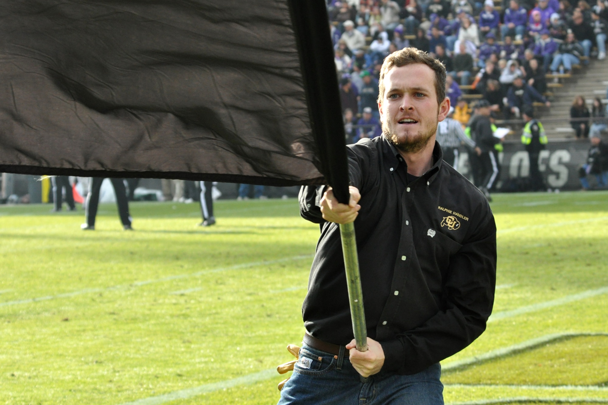 Senior Alex Reedy, waves the University of Colorado flag after a CU touchdown during the game against Kansas State University at Folsom Field in Boulder, Colo., Nov. 20, 2010. Reedy is one of 14 handlers who take care of Ralphie, a live buffalo that is one of the more unique mascots in all of intercollegiate athletics. Ralphie, with the help of his handlers, leads the football team out on the field both at the start of the game and second half. CU went up against Kansas State University and came out on top 44-36. (Courtesy photo/Jeff Walston)  