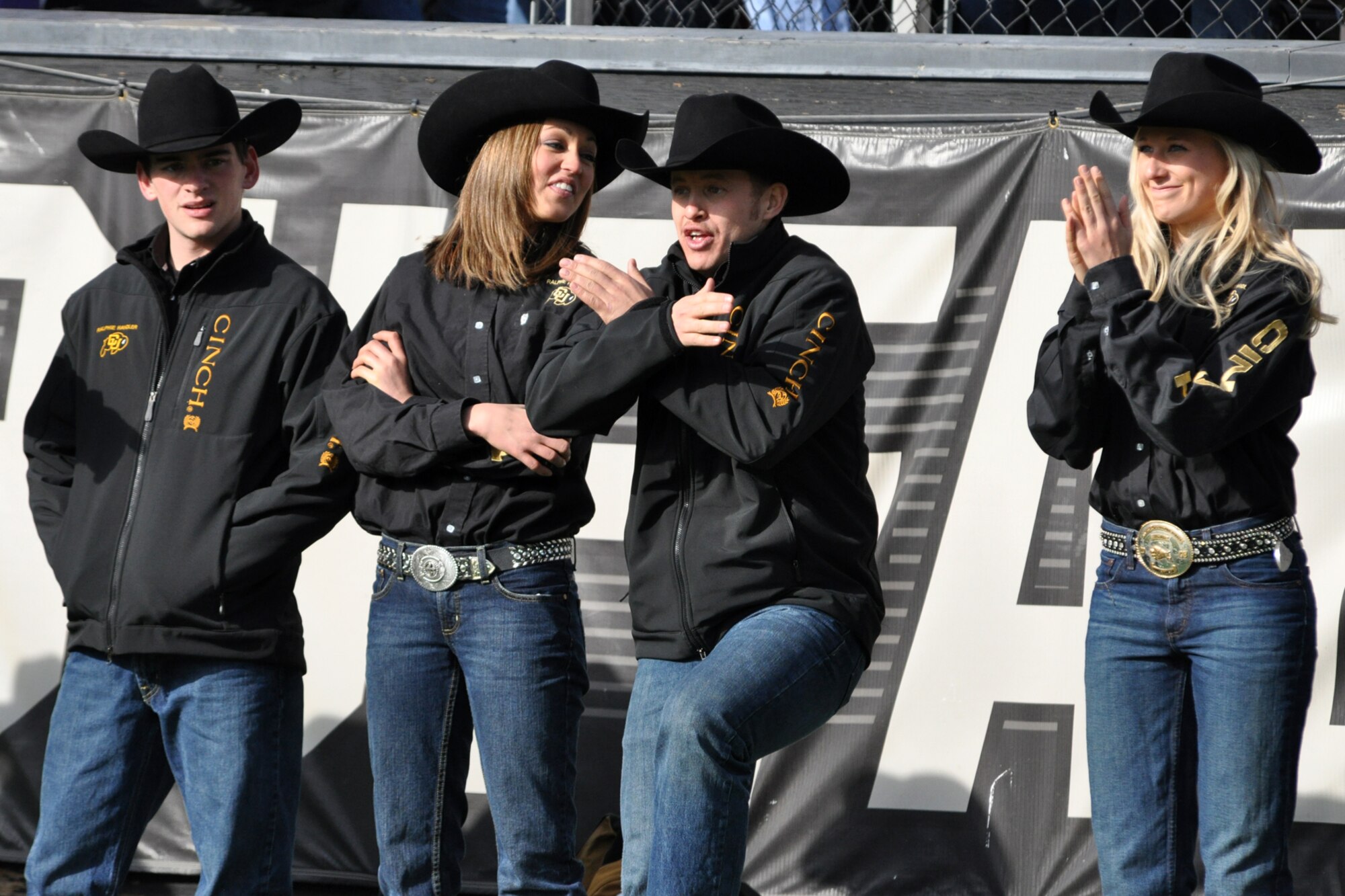 Graduate Student Chip Samson, a Ralphie Handler for the University of Colorado, "busts a move" as his teammate Danielle Morgan looks on during the football game against Kansas State University at Folsom Field in Boulder, Colo., Nov. 20, 2010. Samson and Morgan are two of 14 handlers who take care of Ralphie, a live buffalo that is one of the more unique mascots in all of intercollegiate athletics. She leads the football team out on the field both at the start of the game and second half. CU went on to win the game 44-36. (Courtesy photo/Jeff Walston)  