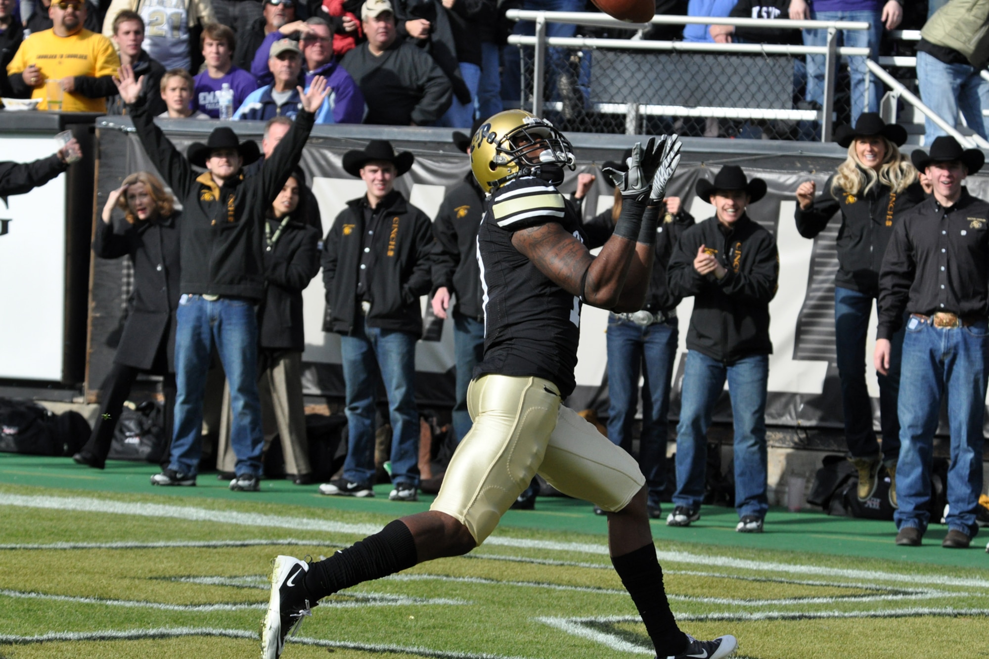Members of the University of Colorado Ralphie Handler Team celebrate a touchdown catch by CU wide receiver Toney Clemons Jr., during the football game against Kansas State University at Folsom Field in Boulder, Colo., Nov. 20, 2010. CU went on to win the game 44-36. (Courtesy photo/Jeff Walston)  