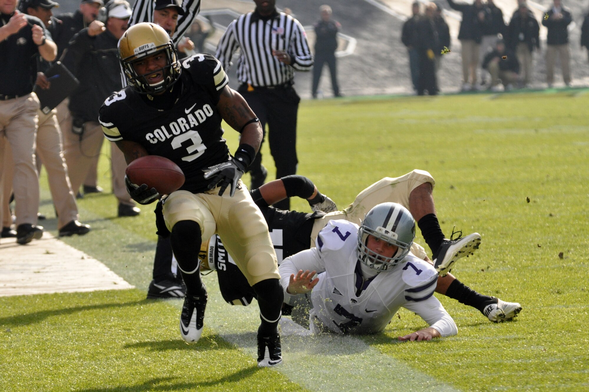 The last line of defense, Kansas State University quarterback Collin Klein (7) shoves University of Colorado cornerback Jimmy Smith (3) out of bounds after he recovers the ball in a fumbled play during the football game at Folsom Field in Boulder, Colo., Nov. 20, 2010. CU went on to score in the drive after the fumble and eventually win the game with K-State 44-36. (Courtesy photo/Jeff Walston)  

