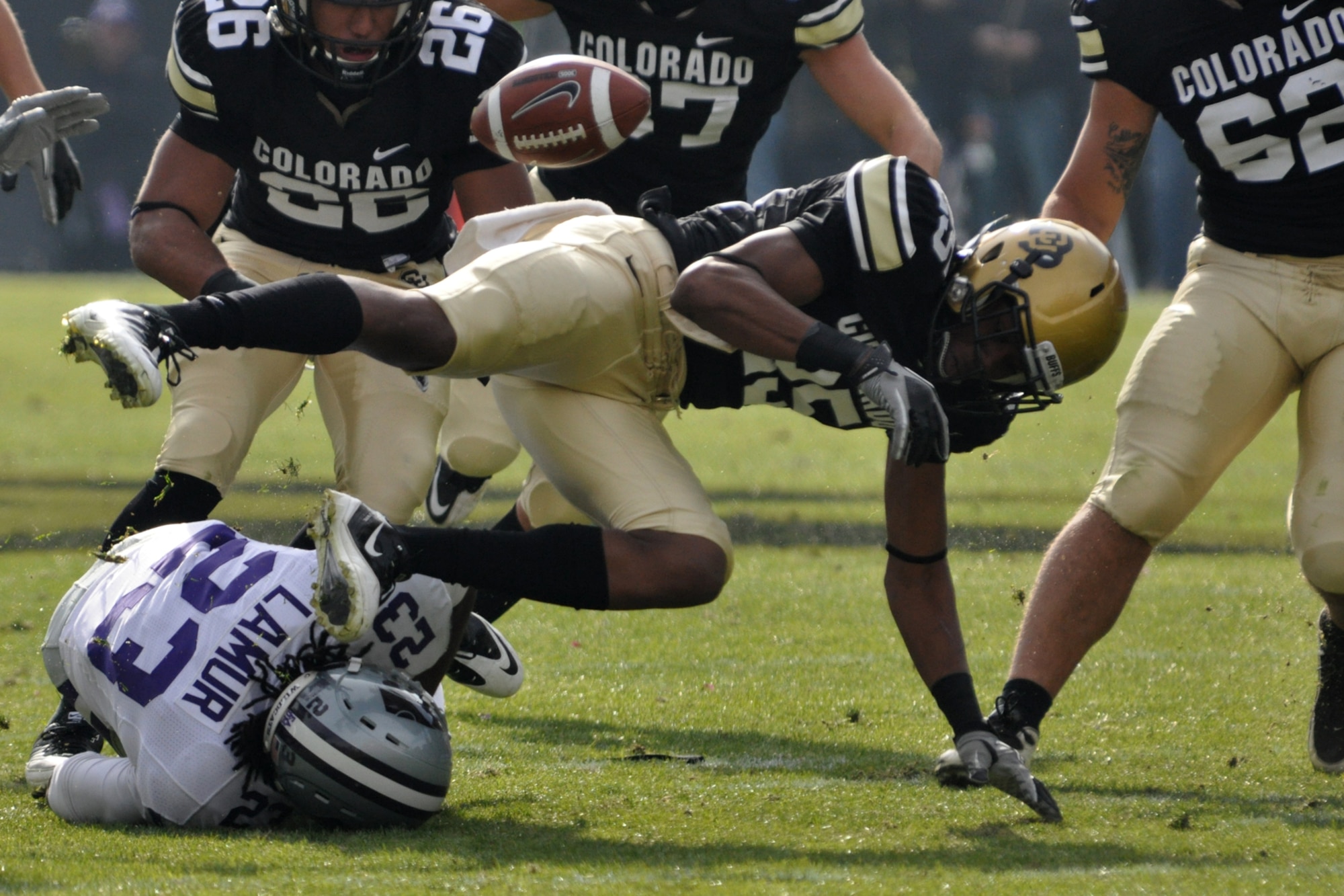 Kansas State University defensive back Emmanuel Lamur (23) and University of Colorado defensive back Deji Olatoye (25) collide as they scramble for the ball after a Kansas State fumble during the football game at Folsom Field in Boulder, Colo., Nov. 20, 2010. CU went on to win the game with K-State 44-36. (Courtesy photo/Jeff Walston)

