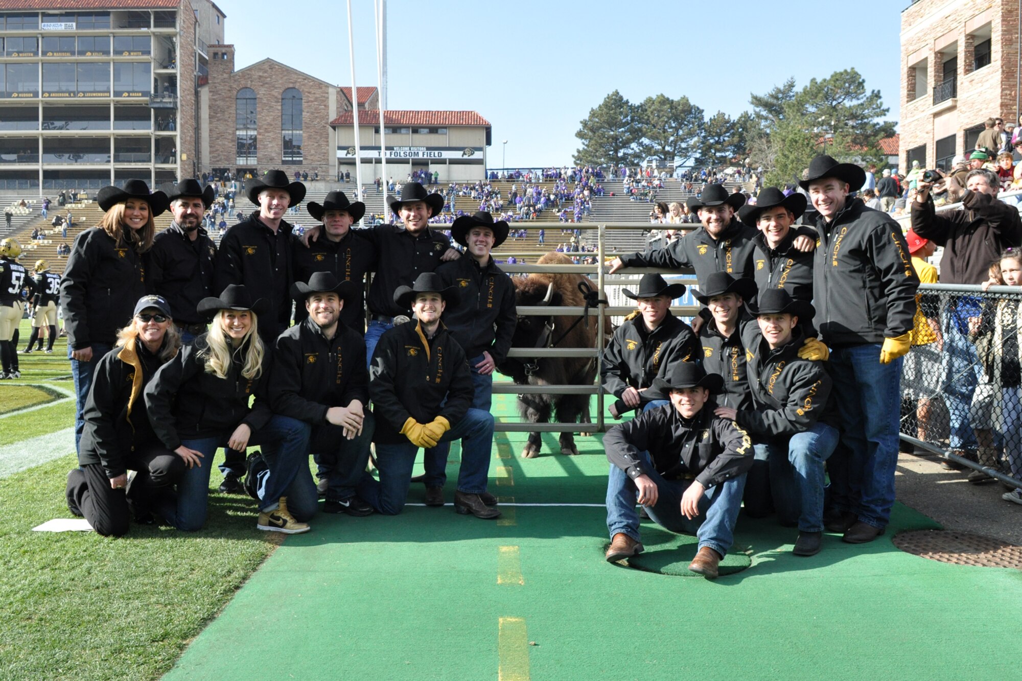 Directors and members of the Ralphie Handler Team from the University of Colorado Standing pose for a group photo at the CU and Kansas State University football game at Folsom Field in Boulder, Colo., Nov. 20, 2010. (Standing) Senior Danielle Morgan, Director Benny Frei, Junior Kellan Phillips, Senior David Gagne, Senior John Delva, Sophomore Rob Seib, Director John Graves, Junior Colin Hinman, and Senior Bryce McDermott. (Kneeling) Director Gail Pederson, Senior Annie Lawson, Graduate Student Sean Tufts, Senior Alex Reedy, Sophomore Taylor James, Sophomore Willy Strazza and Graduate Student Chip Samson. (Sitting) Sophomore Chris Milinazzo. (Courtesy photo/Jeff Walston)