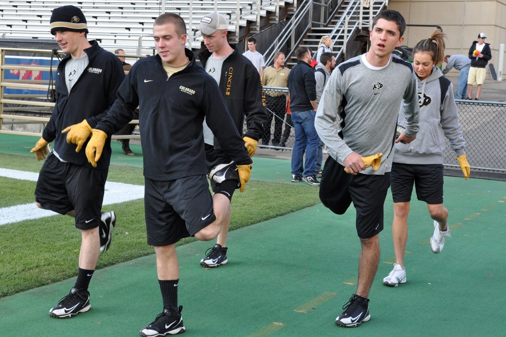 Members of the University of Colorado Ralphie Handler Team, Colin Hinman, Rob Seib, Kellan Phillips, Chris Milinazzo and Danielle Morgan, warm up before a practice session at Folsom Field in Boulder, Colo., Nov. 19, 2010. Ralphie, a live buffalo, is one of the more unique mascots in all of intercollegiate athletics. She leads the football team out on the field both at the start of the game and second half. It was in the final game of the 1934 season, when a live buffalo made its first appearance after a group of students paid $25 to rent a buffalo calf along with a real cowboy as his keeper. It took the cowboy and four students to keep the calf under control on the sidelines during the 7-0 win at the University of Denver on Thanksgiving Day. (Courtesy photo/Jeff Walston)  