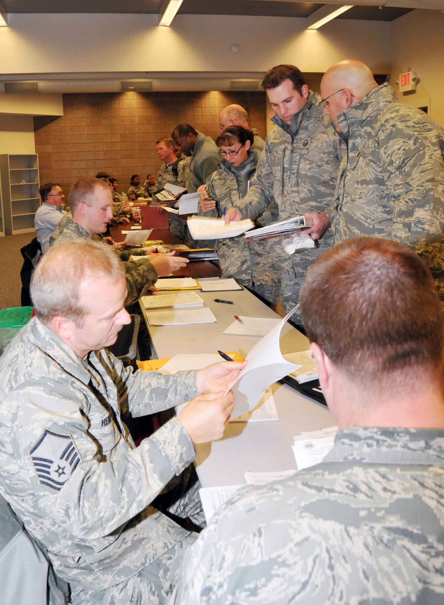 Members of the 27th Aerial Port Squadron process through a deployment line Dec. 21 in preparation for their deployment to Southwest Asia the following day.  The Airmen will provide logistical support for the movement of people and cargo while deployed. (Air Force Photo/Paul Zadach)