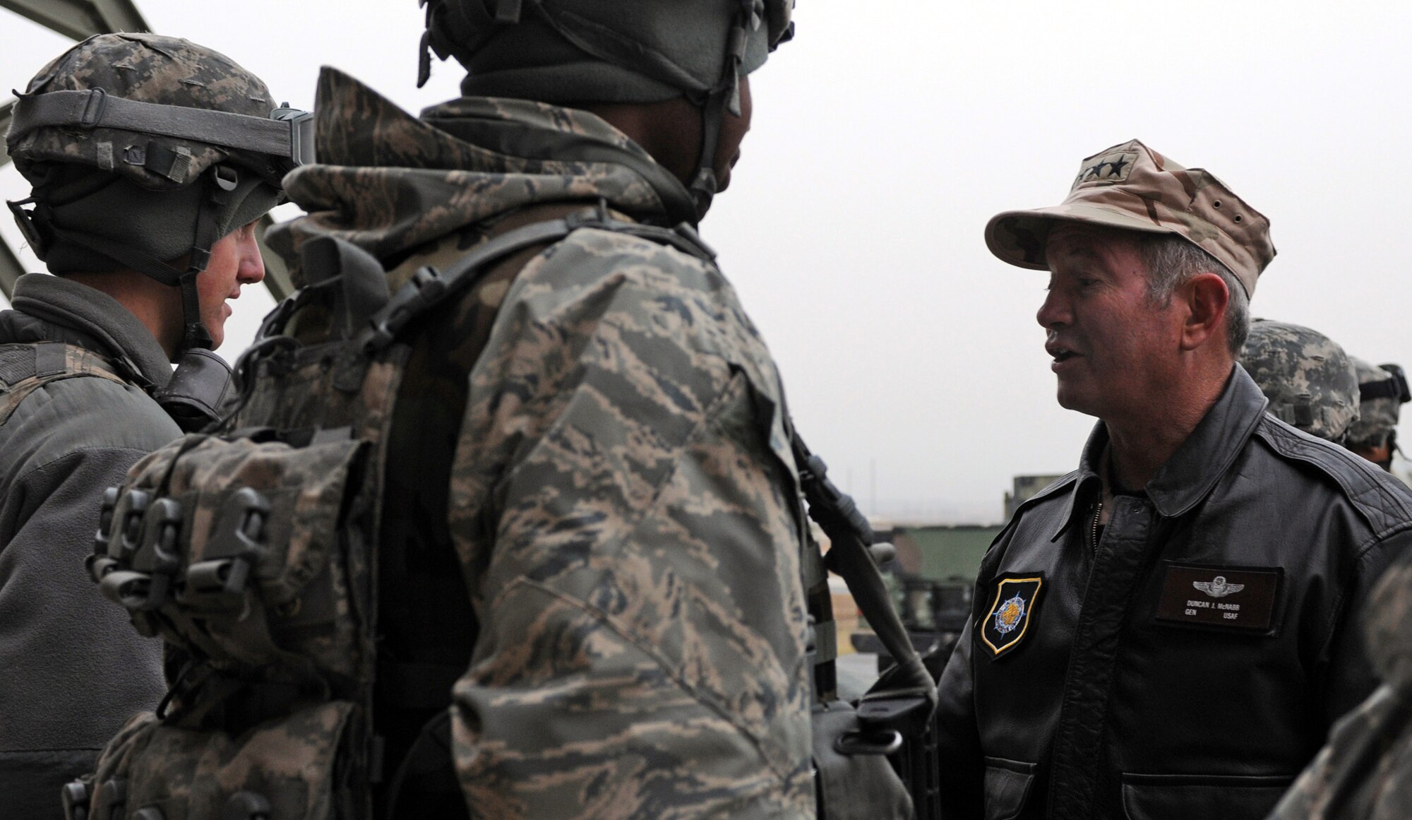 Gen. Duncan J. McNabb, the commander of the U.S. Transportation Command, talks with members of the 39th Security Forces Squadron during his visit Dec. 17, 2010 to Incirlik Air Base, Turkey. During General McNabb’s visit to the 39th Air Base Wing he spoke to Airmen at a commander’s call and visited with members of the 39th Maintenance Squadron, 728th Air Mobility Squadron, 39th SFS and the 90th Expeditionary Air Refueling Squadron. (U.S. Air Force photo by Senior Airman Sara Csurilla/Released)