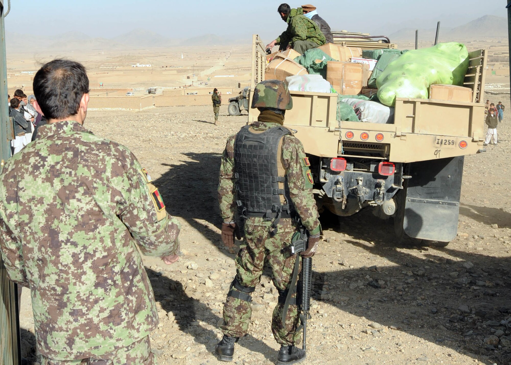 101122-N-6541W-005 KABUL, Afghanistan - Members of the Afghan Air Force  backup a truck in preparation to distribute supplies to children and their families in a village north of Kabul.  (U.S. Navy photo by Mass Communication Specialist 3rd Class Jared Walker/ RELEASED).