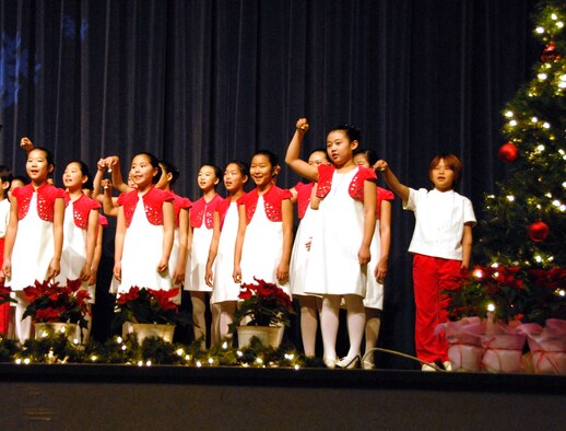 KUNSAN AIR BASE, Republic of Korea -- Children from the Daejeon City Children's Choir treat the Wolf Pack to a performance in the base theater Dec. 19. The Far East Broadcast Company’s 50-member Daejeon City Korean Children’s Choir sang, performed fan and drum dances, and dressed in traditional Korean outfits during the show. (U.S. Air Force photo/Staff Sgt. Amanda Savannah)