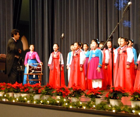 KUNSAN AIR BASE, Republic of Korea -- Yim Kwon-Mok, choir maestro, leads the Daejeon City Children's Choir during their performance in the base theater Dec. 19. The Far East Broadcast Company’s 50-member Daejeon City Korean Children’s Choir sang, performed fan and drum dances, and dressed in traditional Korean outfits during the show. (U.S. Air Force photo/Staff Sgt. Amanda Savannah)