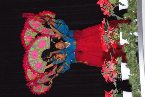 KUNSAN AIR BASE, Republic of Korea -- Children from the Daejeon City Children's Choir perform a fan dance during their performance in the base theater Dec. 19. The Far East Broadcast Company’s 50-member Daejeon City Korean Children’s Choir was invited to Kunsan by the base chapel to bring holiday greetings to Wolf Pack personnel for the holidays. (U.S. Air Force photo/Staff Sgt. Amanda Savannah)