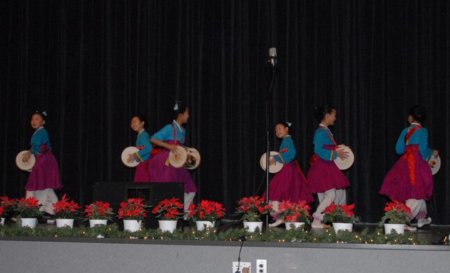 KUNSAN AIR BASE, Republic of Korea -- Children from the Daejeon City Children's Choir perform a drum dance during their performance in the base theater Dec. 19. The Far East Broadcast Company’s 50-member Daejeon City Korean Children’s Choir was invited to Kunsan by the base chapel to bring holiday greetings to Wolf Pack personnel for the holidays. (U.S. Air Force photo/Staff Sgt. Amanda Savannah)