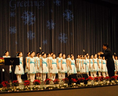 KUNSAN AIR BASE, Republic of Korea -- Yim Kwon-Mok, choir maestro, leads the Daejeon City Children's Choir in a song during their performance in the base theater Dec. 19. The Far East Broadcast Company’s 50-member Daejeon City Korean Children’s Choir sang, performed fan and drum dances, and dressed in traditional Korean outfits during the show. (U.S. Air Force photo/Staff Sgt. Amanda Savannah)