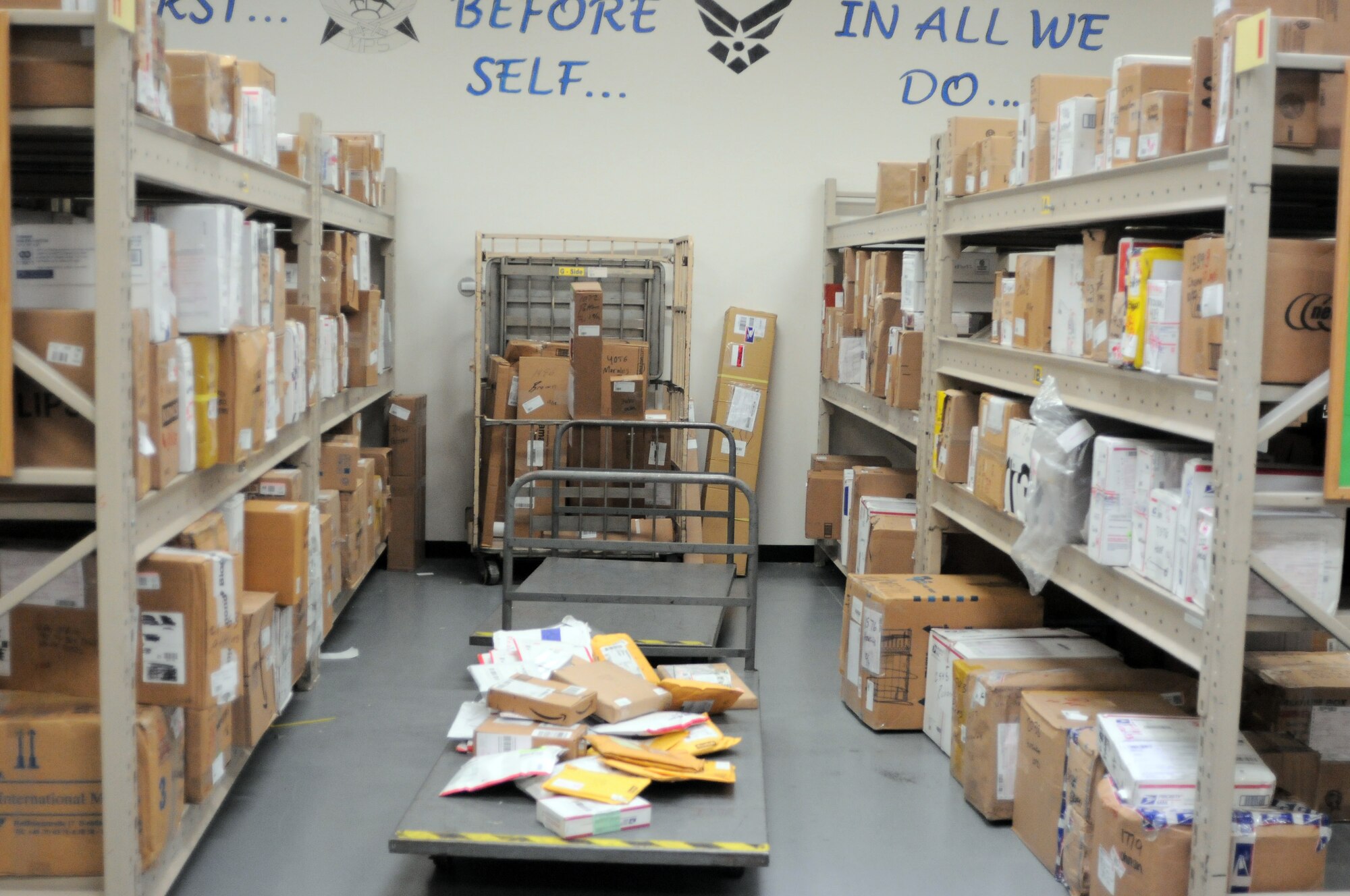 YOKOTA AIR BASE, Japan -- More and more shelves are being over stocked with holiday mail at the Yokots Post Office here Dec. 17. The Yokota Post Office relies on volunteers to help sort through thousends of boxes and letters during the holiday.(U.S. Air Force photo/ 2nd Lt. Christopher Love )