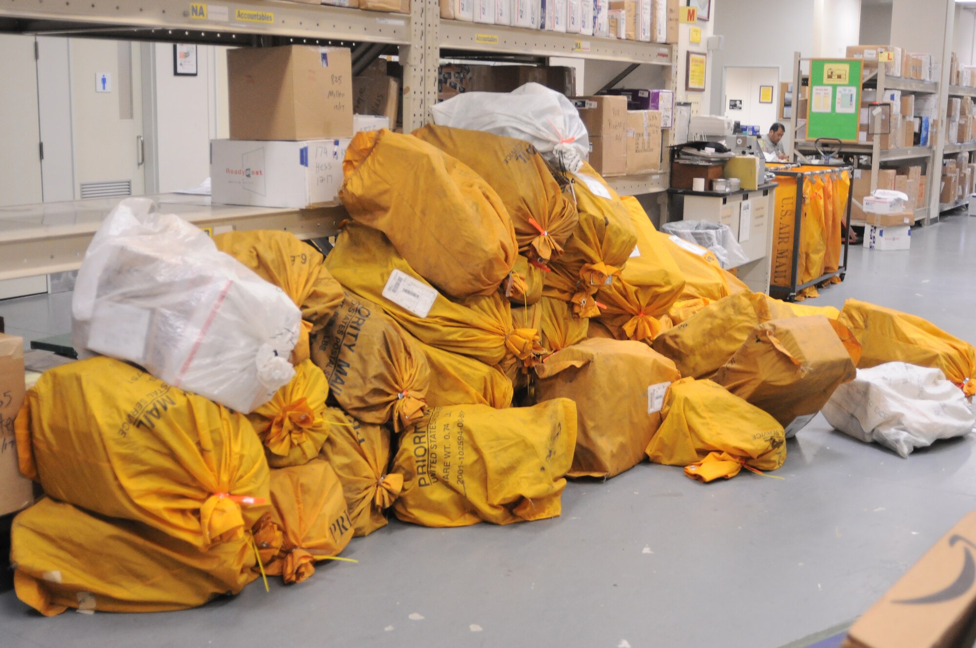 YOKOTA AIR BASE, Japan -- A mountain of mail awaits processing and sorting inside the Post Office here Dec. 17. The Yokota Post Office relies on volunteers to help sort through thousends of boxes and letters during the holiday. (U.S. Air Force photo/ 2nd Lt. Christopher Love )