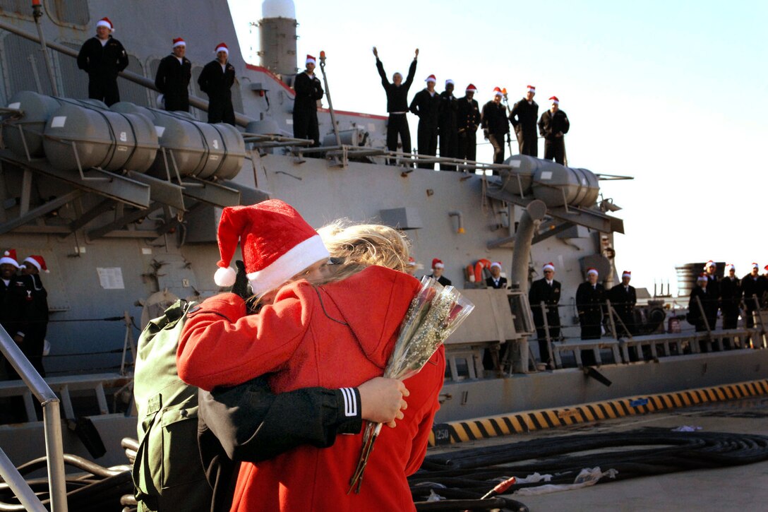 U.S. Navy Petty Officer 2nd Class Matthew Mosely embraces his wife just in time for the holidays in Norfolk, Va., Dec. 20, 2010. Mosely was deployed with the guided-missile destroyer USS Ross for seven months in support of maritime security operations in Iraq, Afghanistan and the Mediterranean Sea.  