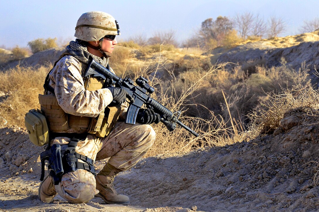 U.S. Marine Corps Gunnery Sgt. Javier Vega pauses for a security halt while conducting perimeter security checks around a new combat outpost in Diwar, Afghansitan, Dec. 18, 2010. Vega is assigned to Naval Mobile Construction Battalion 40.