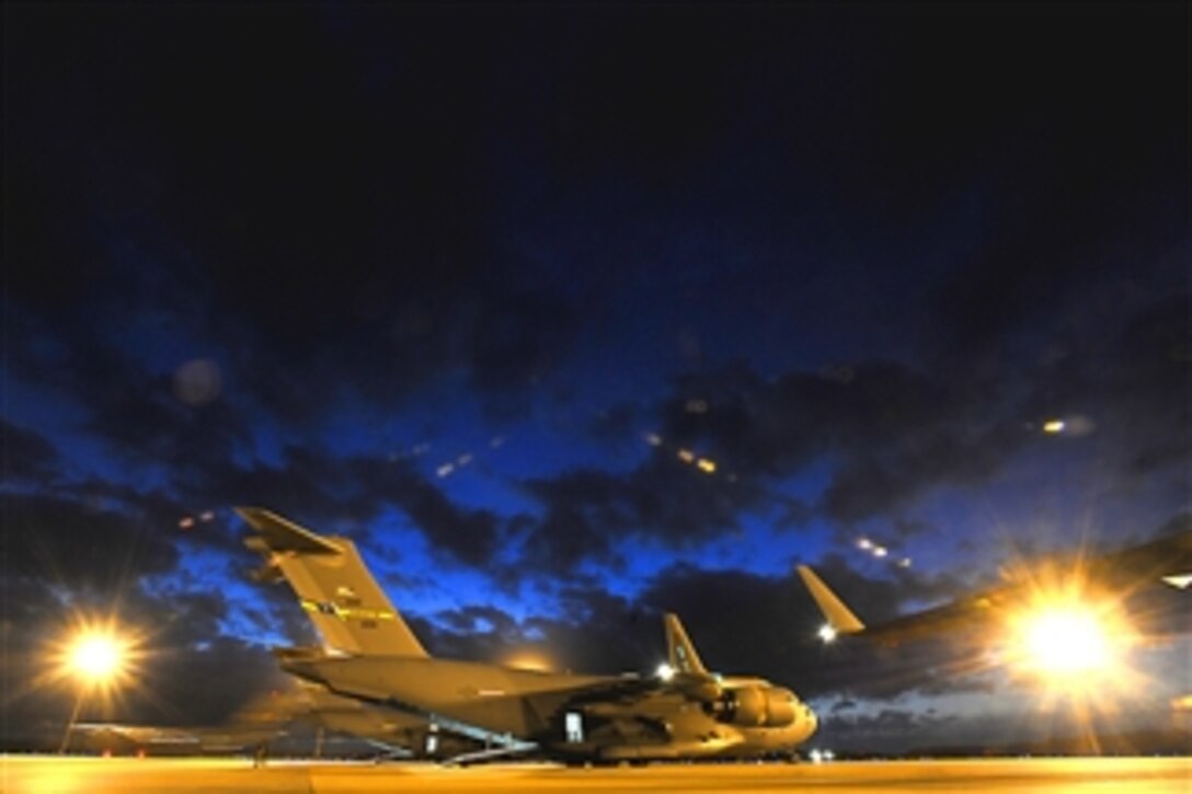 A U.S. Air Force C-17 Globemaster III aircraft sits on a runway at Fort Polk, La., before picking up soldiers for an airdrop mission during a formation exercise on Dec. 15, 2010.  The large formation exercise demonstrates the global projection of U.S. airpower and the mission to perform aerial refueling training.  The soldiers are assigned to Task Force 1, Operations Group at the Joint Readiness Training Center.  