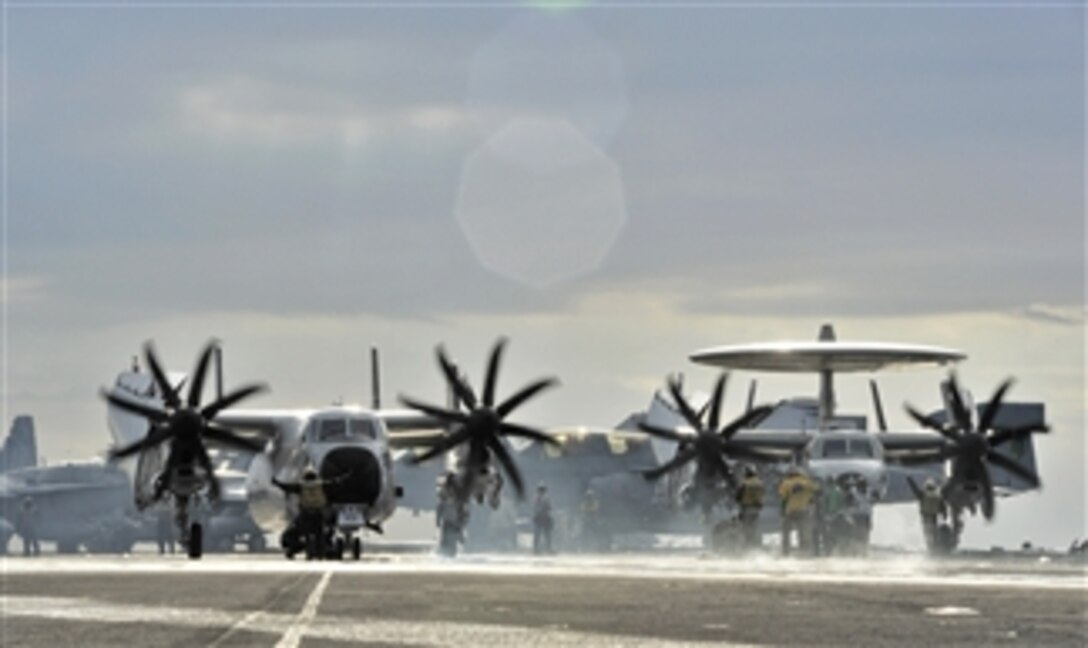 A C-2A Greyhound assigned to Fleet Logistics Support Squadron 40 and an E-2C Hawkeye assigned to Airborne Early Warning Squadron 126 prepare to launch from the aircraft carrier USS Harry S. Truman (CVN 75) underway in the Atlantic Ocean on Dec. 18, 2010.  
