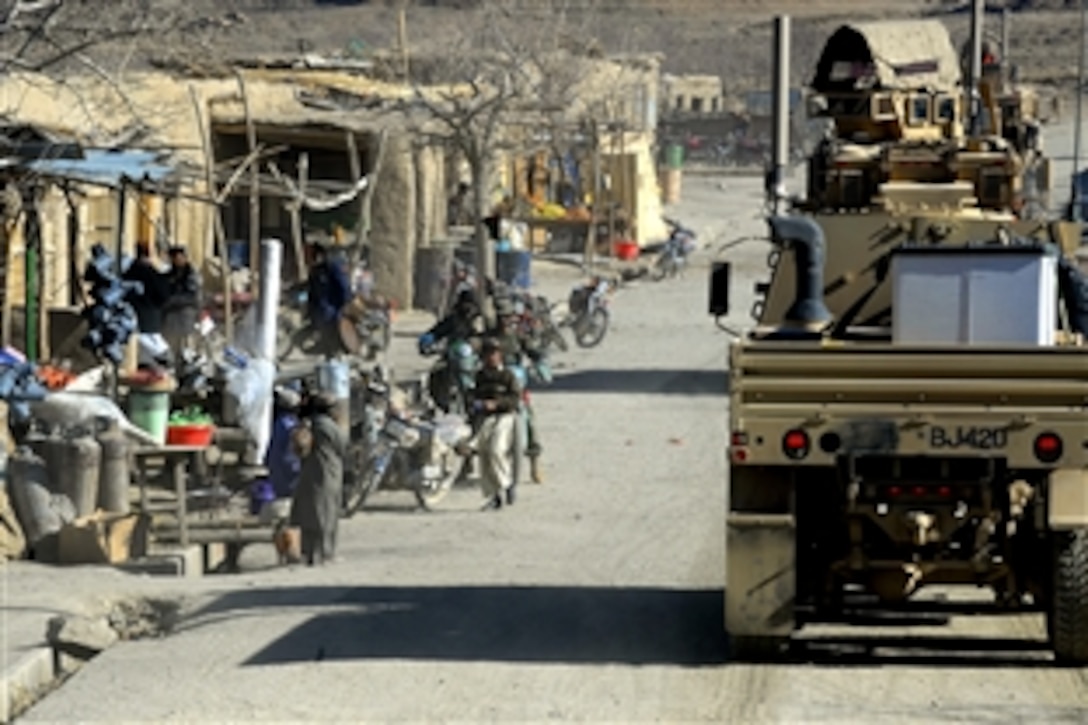 A U.S. military convoy enters the village of Shinkay, Qalat, Afghanistan, Dec. 21, 2010. 